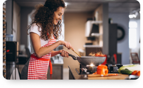 woman-chef-cooking-vegetables-pan-1.png